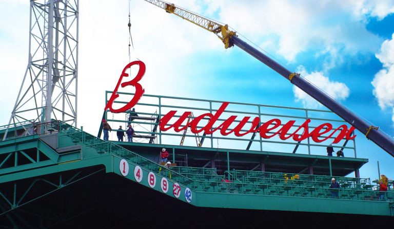 Budweiser sign installation at Fenway Park using crane for large-scale stadium signage