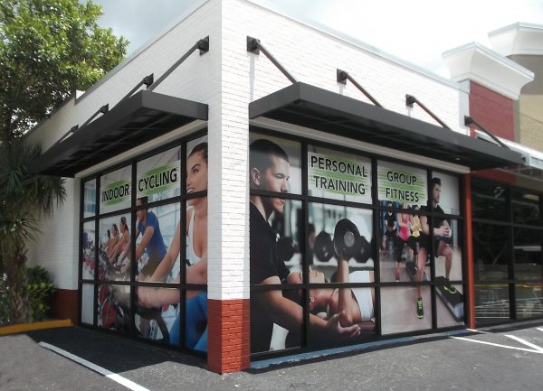 Custom window graphics for Xtreme Fitness designed by Thomas Sign to enhance storefront branding.