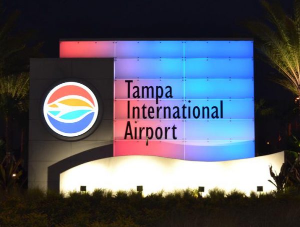 Tampa International Airport monument sign with illuminated LED display at night.