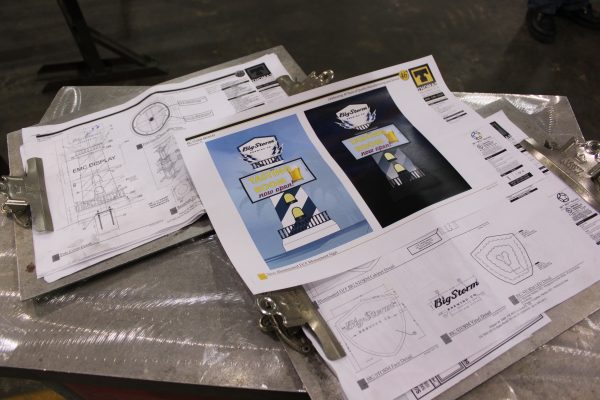 Custom signage design layouts and project drawings on display
