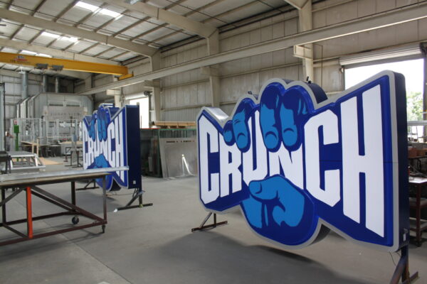 Crunch Fitness sign being fabricated inside Thomas Sign & Awning’s Clearwater, Florida manufacturing facility