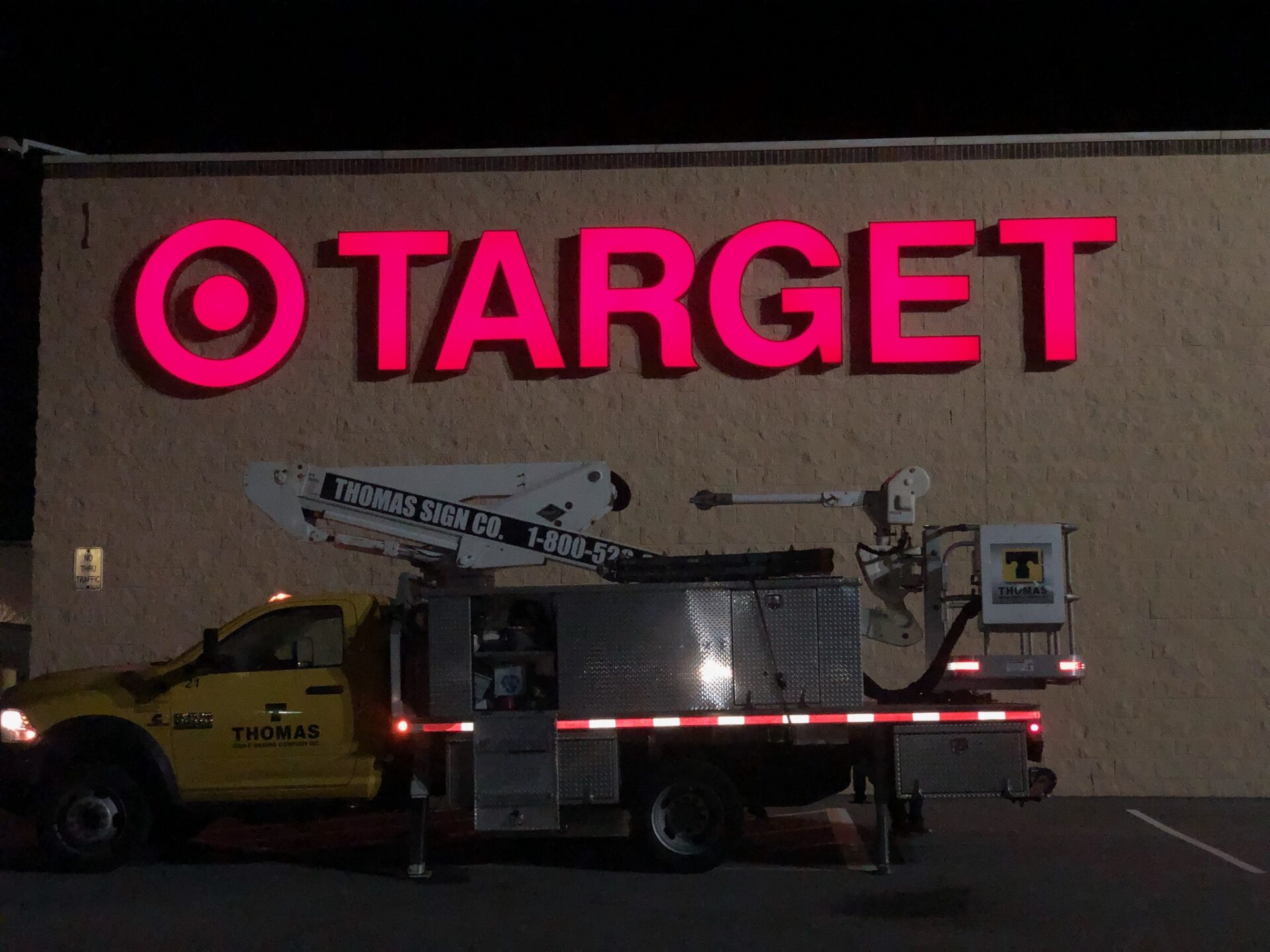 Target storefront illuminated channel letter sign installation at night in Orlando Florida