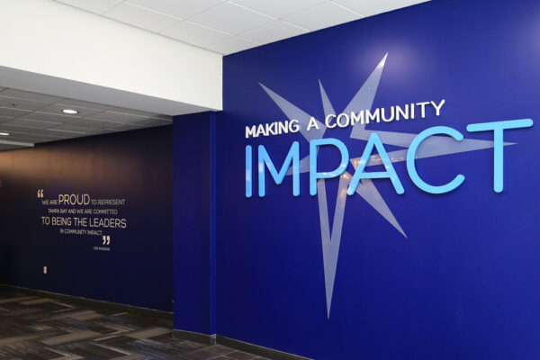 Interior lobby sign with dimensional lettering and wall graphics for corporate office branding