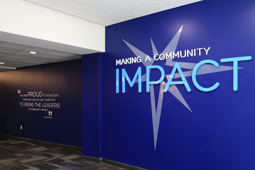 Interior lobby sign with dimensional lettering and wall graphics for corporate office branding