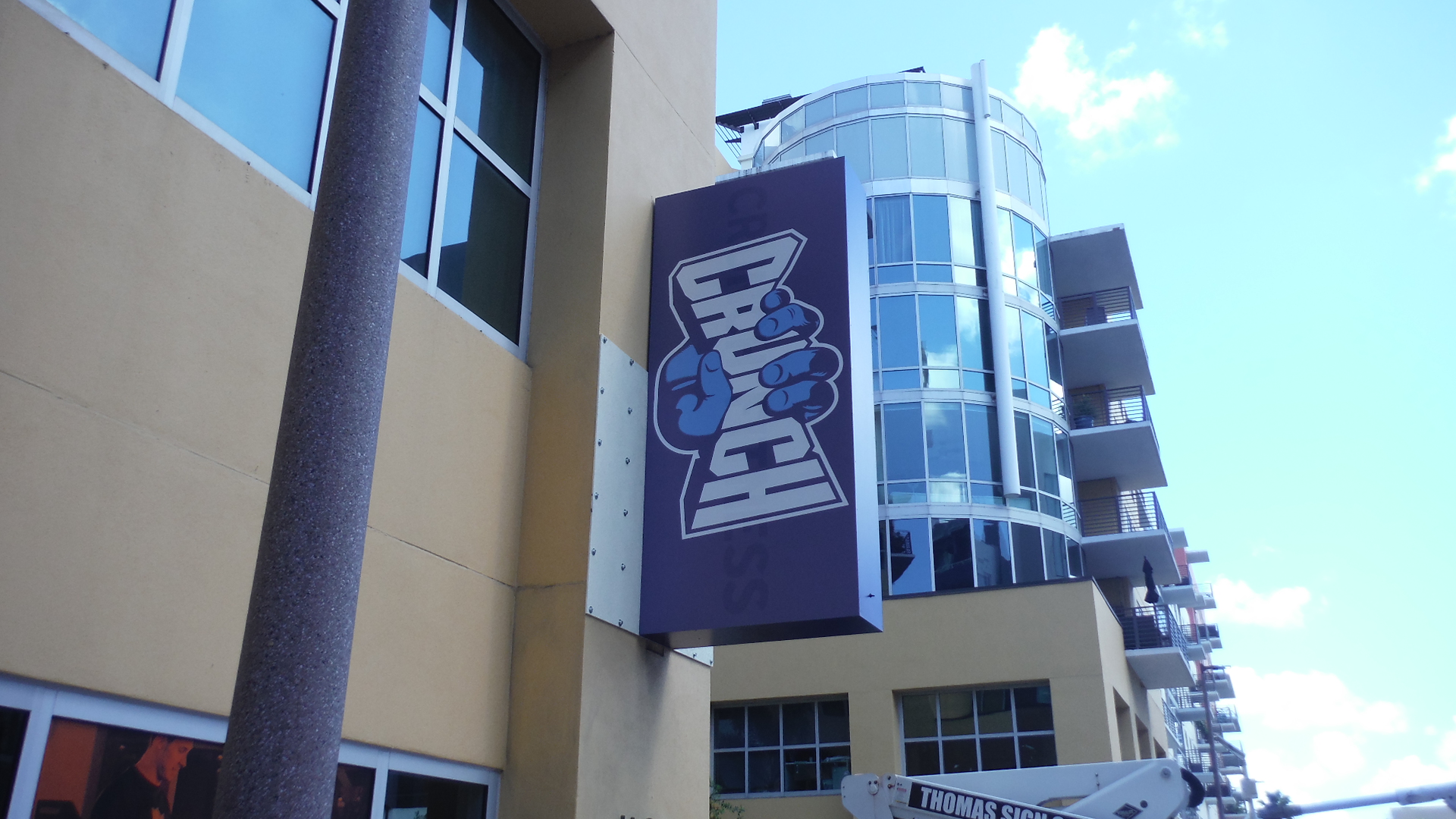 Exterior blade sign projecting from building to identify gym location and improve visibility