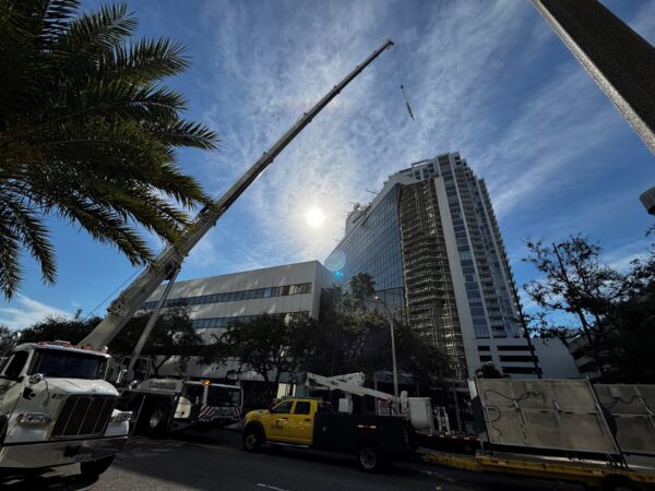 High rise sign installation for Acron Aviation using crane and lift equipment on commercial building