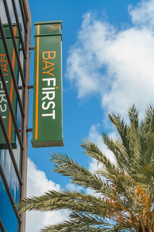 Exterior blade sign projecting from building to identify bank location and improve visibility