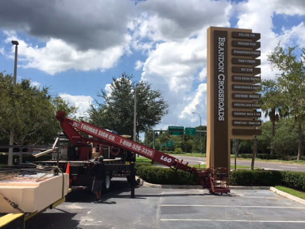 Pylon sign installation at Brandon Crossroads shopping center using crane equipment