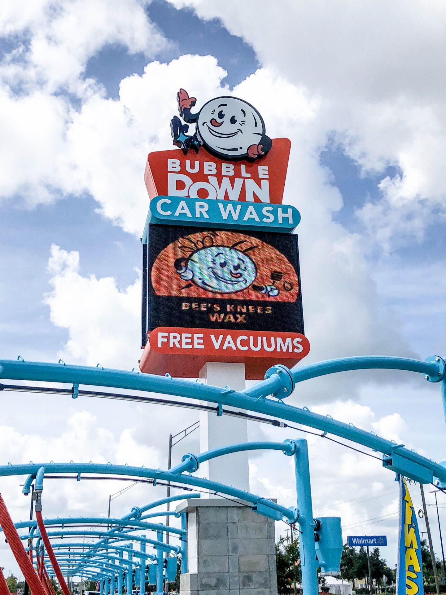 Pylon sign with electronic message center at Bubble Down Car Wash displaying digital advertising