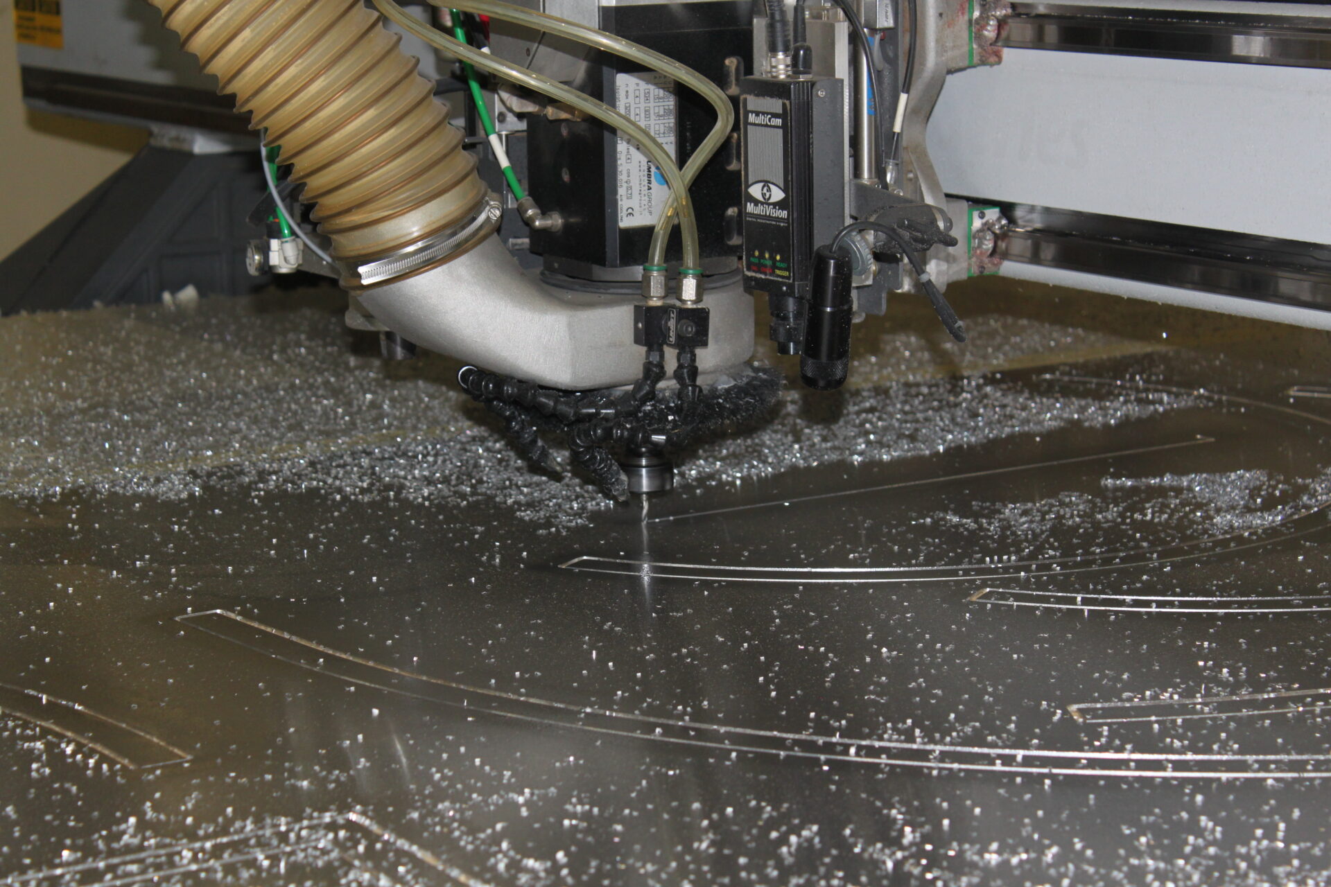 CNC routing machine cutting material for custom sign manufacturing and fabrication
