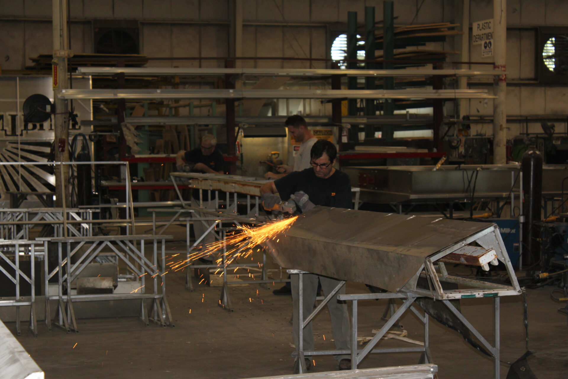 Metal fabrication process for sign structure using cutting tools in manufacturing facility