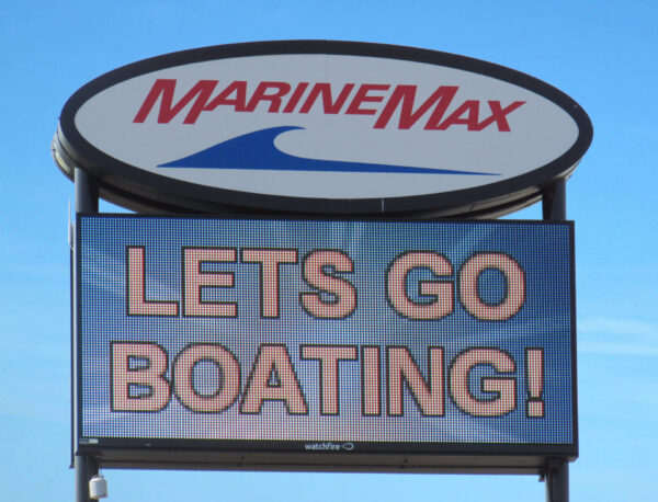 LED electronic message center display showing Lets Go Boating message on MarineMax sign