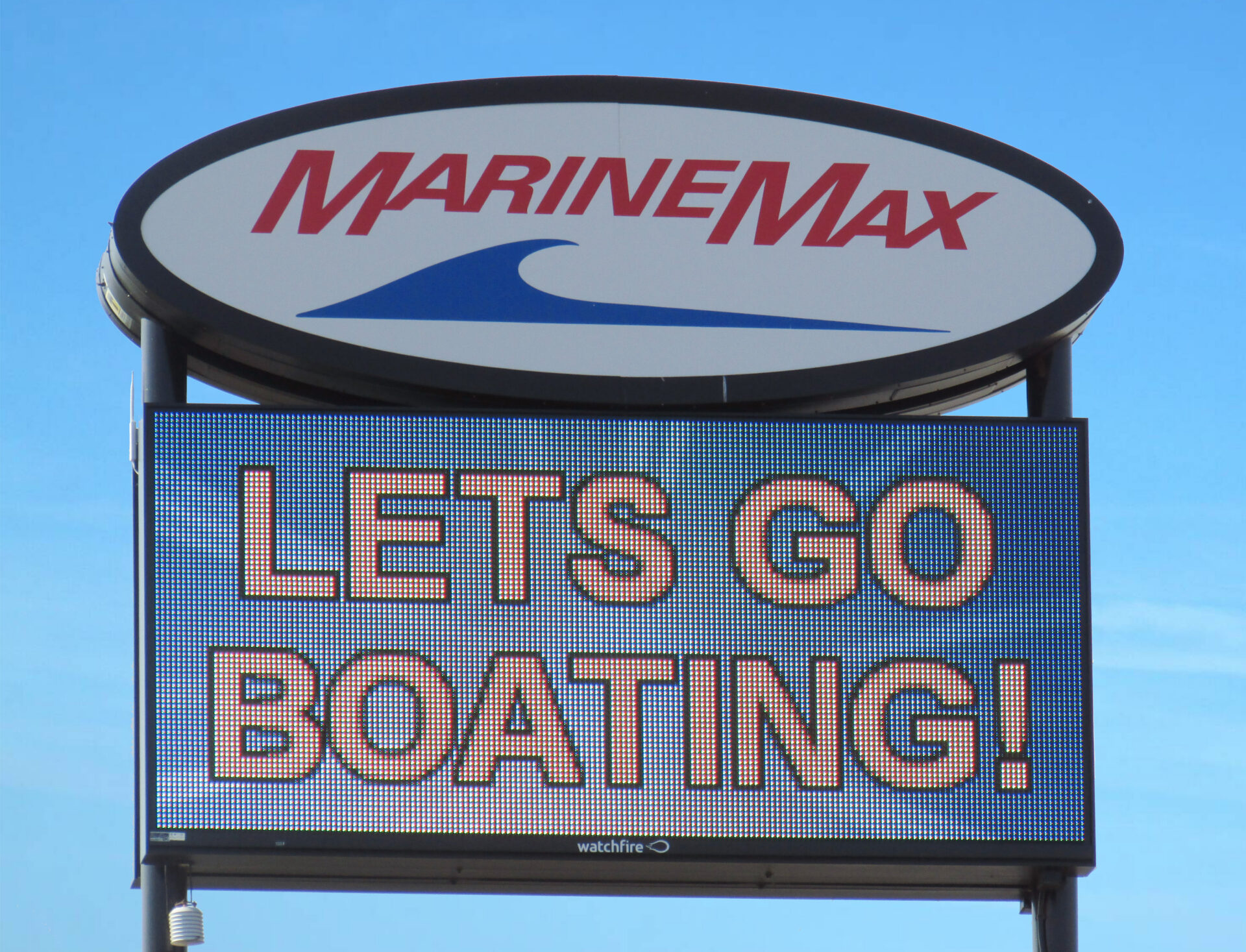 LED electronic message center display showing Lets Go Boating message on MarineMax sign