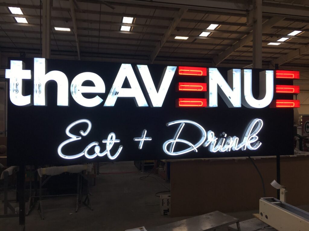 Illuminated channel letter and neon sign for theAvenue in sign manufacturing facility