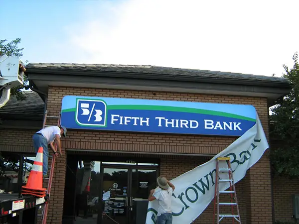 Technicians installing new Fifth Third Bank signage during a rebranding conversion project by Thomas Sign & Awning