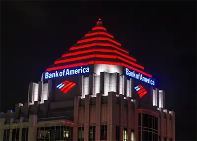 High-rise building signage with illuminated corporate branding on commercial office tower at night