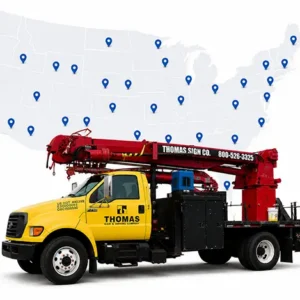 Thomas Sign service truck displayed over a U.S. map representing nationwide signage installation and rollout capabilities by Thomas Sign & Awning