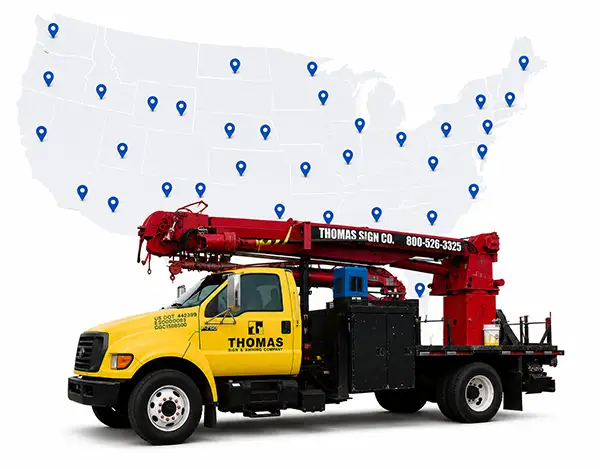 Thomas Sign service truck displayed over a U.S. map representing nationwide signage installation and rollout capabilities by Thomas Sign & Awning