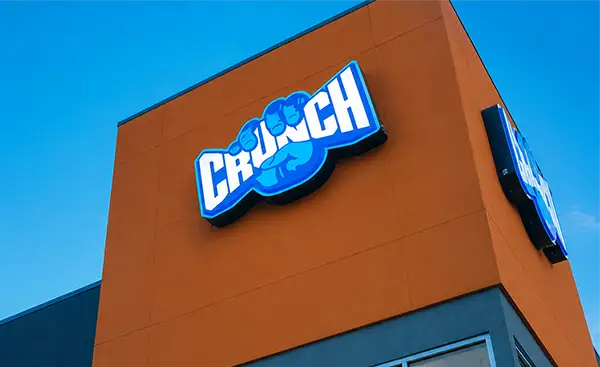 Commercial wall sign installed on a retail building with illuminated storefront signage