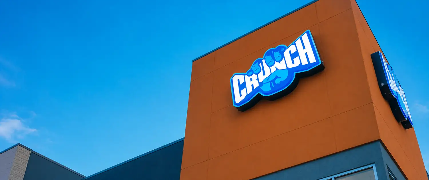 Commercial wall sign installed on a retail building with illuminated storefront signage