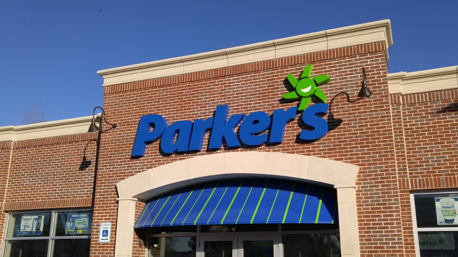 Front lit channel letter sign mounted on gas station exterior for convenience store branding and visibility