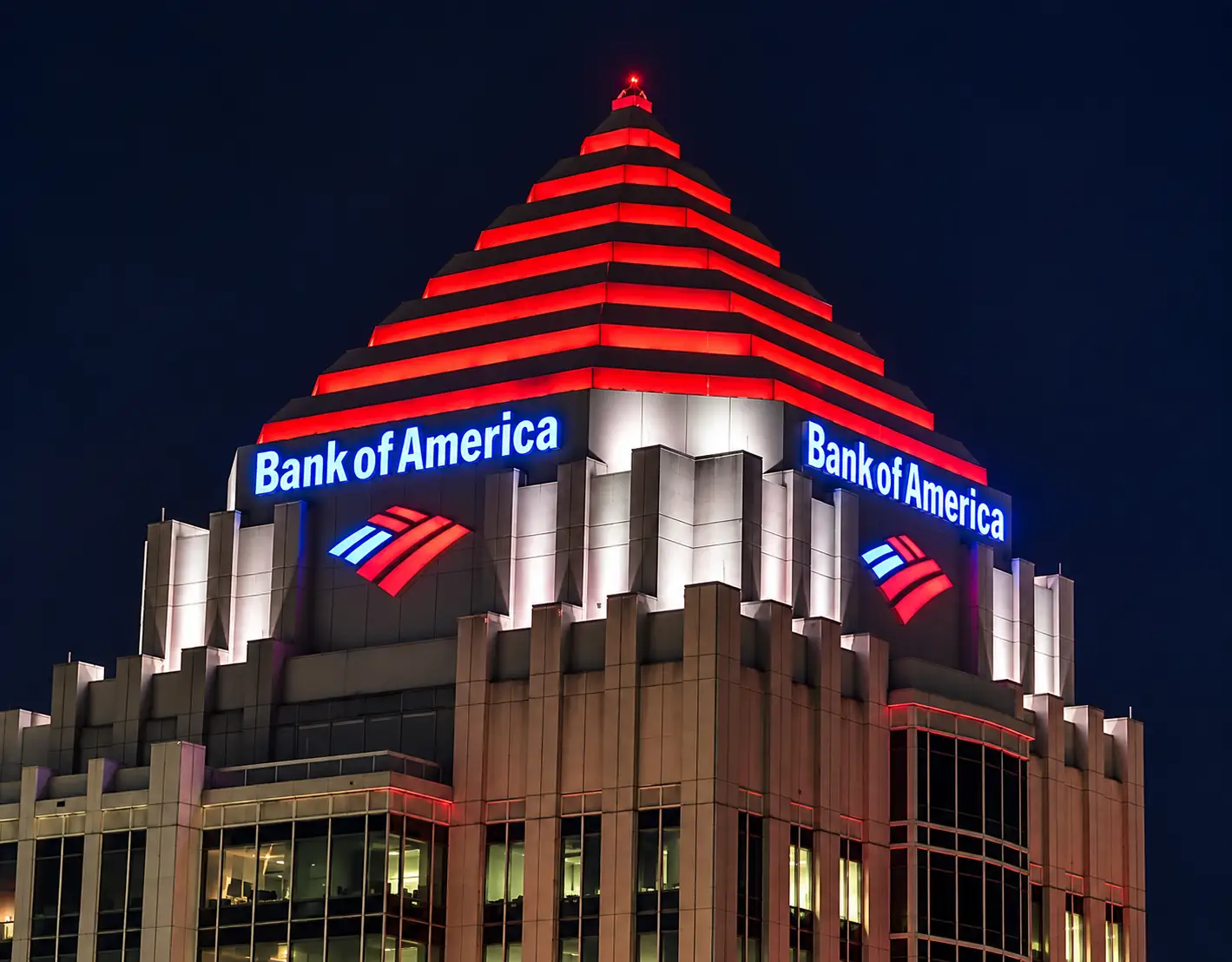 Bank of America illuminated building signage installed on a high-rise building at night