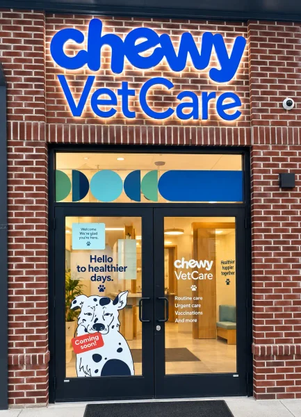 Chewy Vet Care storefront with illuminated exterior signage, branded entrance graphics, and window graphics.