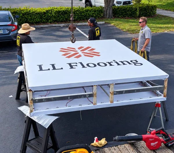 LL Flooring sign being prepared for installation during the national rebranding program