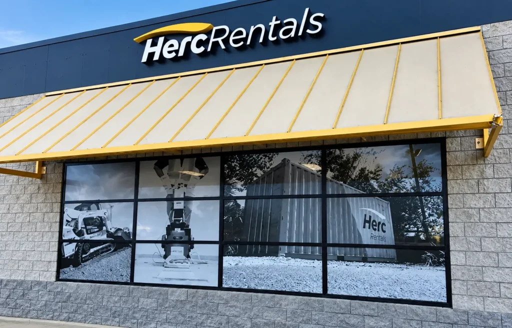 Herc Rentals storefront with channel letters, awning and window graphics