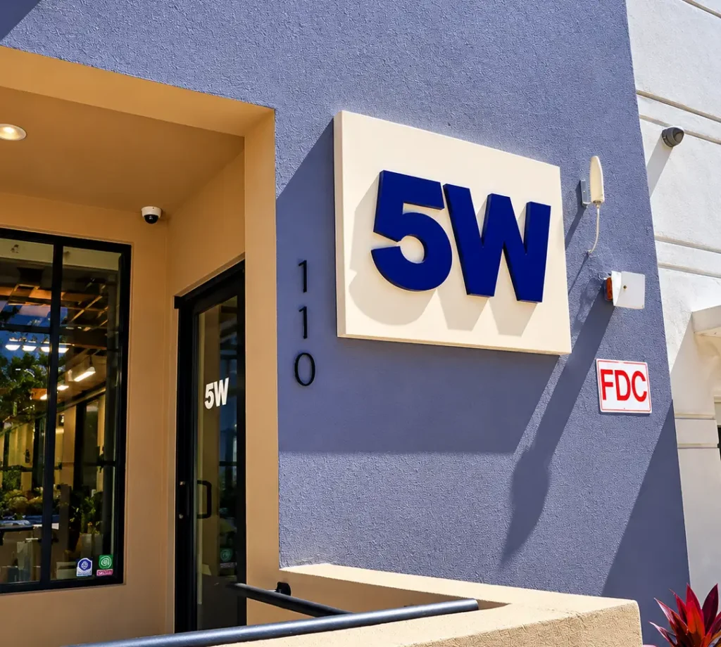 Custom 5WPR exterior wall sign with blue dimensional acrylic lettering on an aluminum panel in Tampa, Florida.