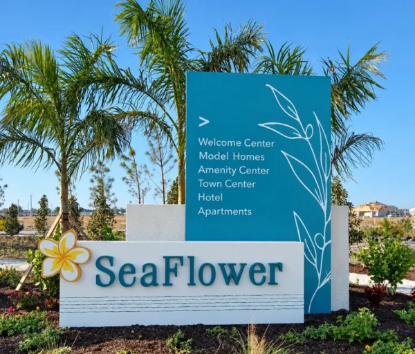 SeaFlower monument sign with dimensional lettering, flower logo and a teal directional panel