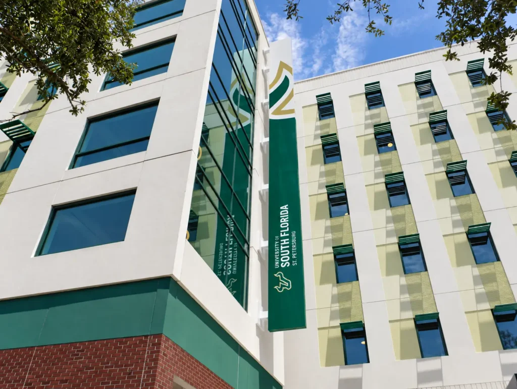 Green vertical USF identification sign on the St. Petersburg residence hall