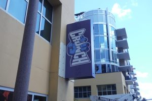 Exterior blade sign projecting from building to identify gym location and improve visibility