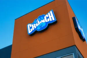 Commercial wall sign installed on a retail building with illuminated storefront signage