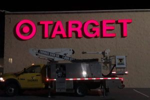 Target storefront illuminated channel letter sign installation at night in Orlando Florida