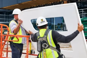 Thomas Sign & Awning technicians installing a commercial sign using a bucket truck